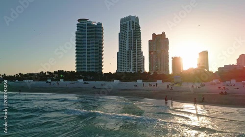 Miami beach holiday skyline sunset. Miami aerial panorama oceanfront. Miami waterfront bay evening. Miami downtown skyline clouds.