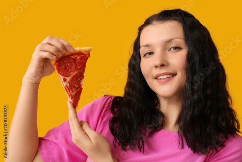 Smiling young woman holding...