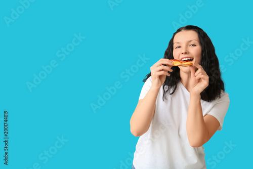 Young woman eating deliciou...