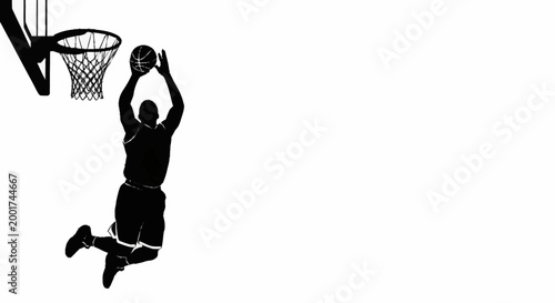 Silhouette of a basketball player performing a slam dunk