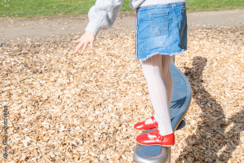 Photography Child walking balance beam in park, Little girl balancing outdoor equipment, gre