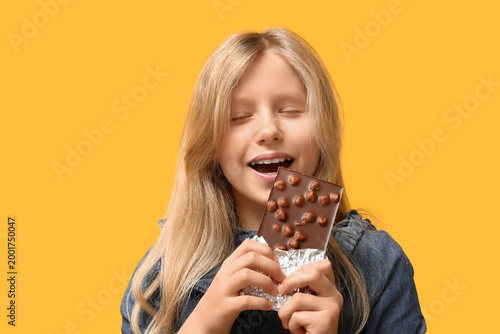 Cute little girl eating swe...
