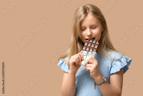 Cute little girl eating swe...
