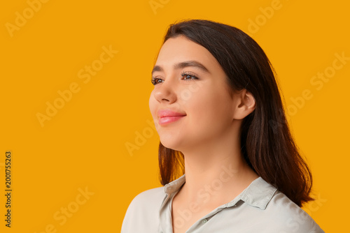 Young happy woman on yellow...