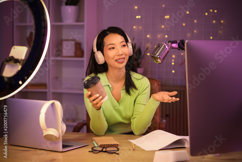 Young Asian woman with coff...