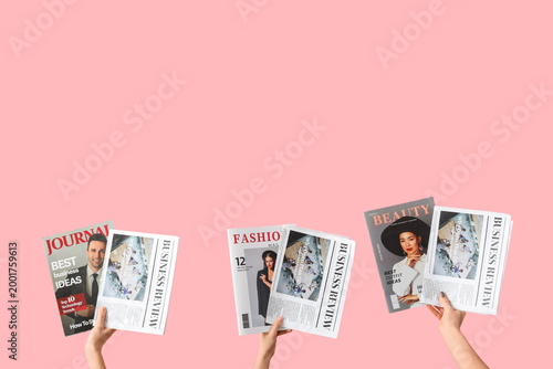 Women with newspapers and magazines on pink background