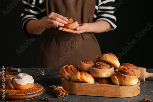 Woman preparing tasty cinna...