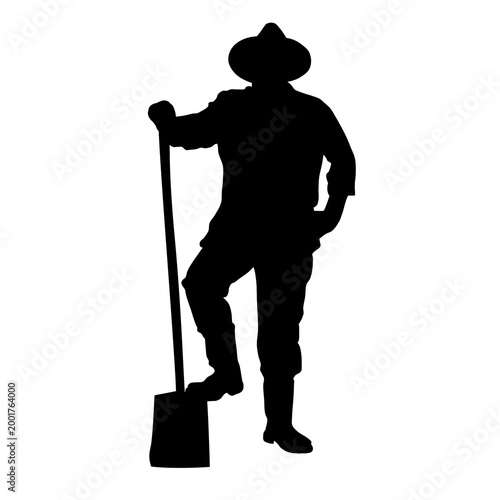 A silhouette of a person wearing a hat and boots, standing with one foot on a shovel.
