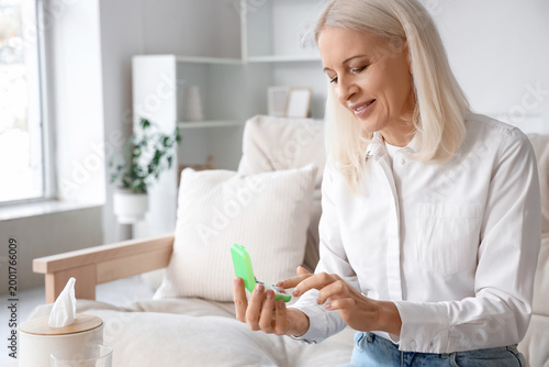 Mature woman selecting pill...