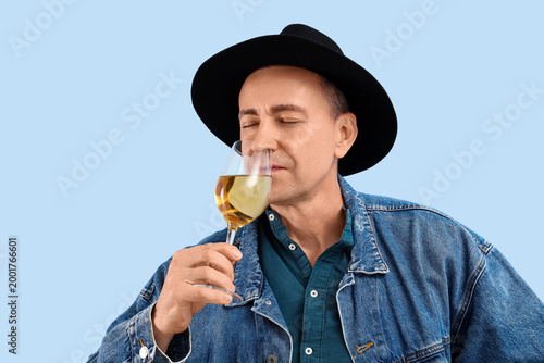 Mature man drinking wine on...