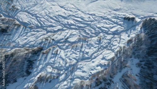 Aerial view of a vast glacier with intricate ice patterns.