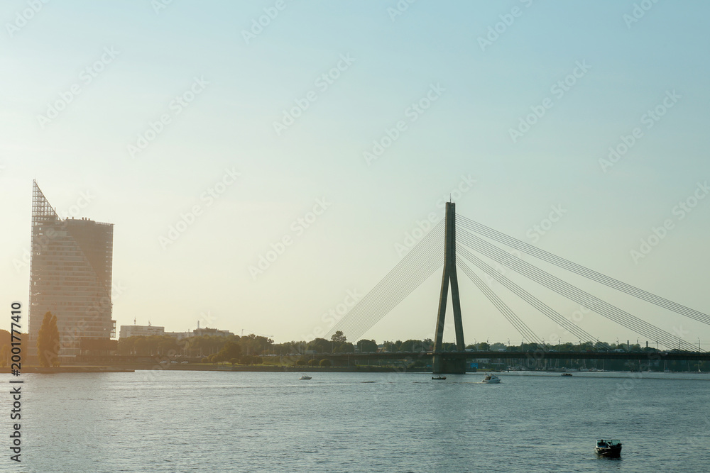 Obraz premium View of beautiful river with modern bridge and building in European city on sunny day