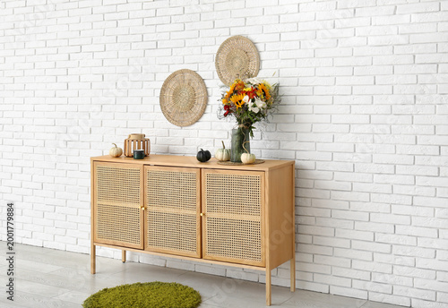 Wooden cabinet with bouquet...