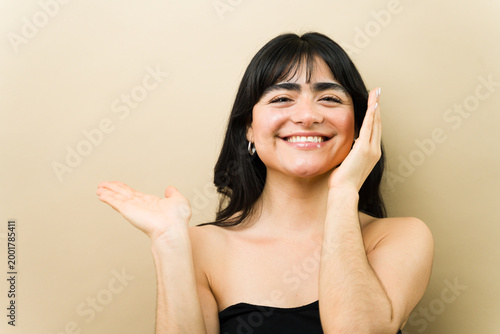 Fotografie Happy woman confidently smiling, presenting radiant skin and beauty, promoting s