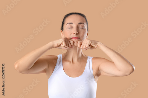 Mature woman doing face yog...