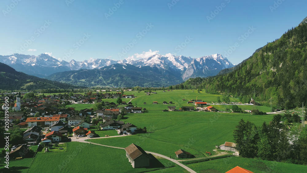 Naklejka premium Village landscape with dramatic mountains