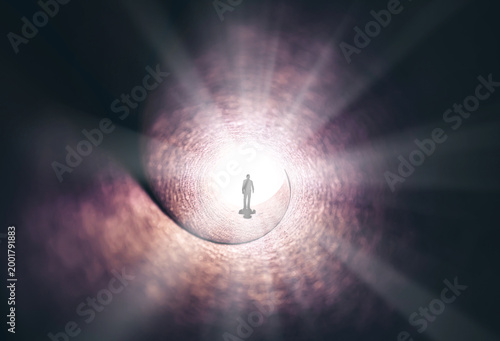 A man walks through a long tunnel toward a bright light. Topics: religion, God, soul, faith, light at the end of the tunnel, life after death, another world, freedom of choice, open mind, meditation.