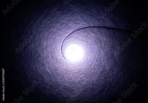 A bright light at the end of a long stone tunnel. Concepts of religion, God, soul, faith, light at the end of the tunnel, life after death, another world, freedom of choice, open mind, meditation.