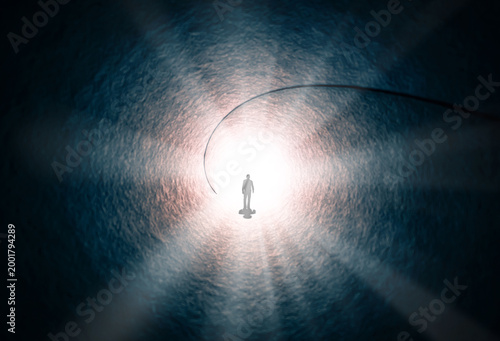 A man walks through a long tunnel toward a bright light. Topics: religion, God, soul, faith, light at the end of the tunnel, life after death, another world, freedom of choice, open mind, meditation.