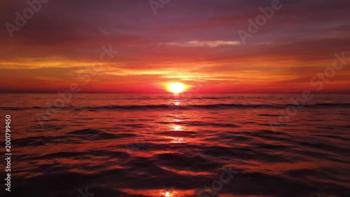 Sunset over calm sea water.
