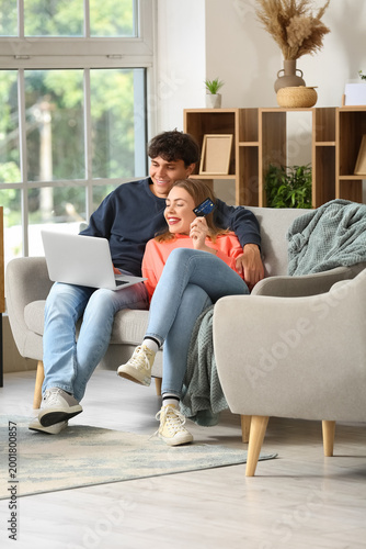 Young couple with laptop an...