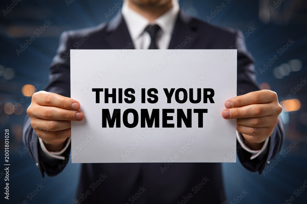 Naklejka premium An empowering and timely message on a sign: This Is Your Moment