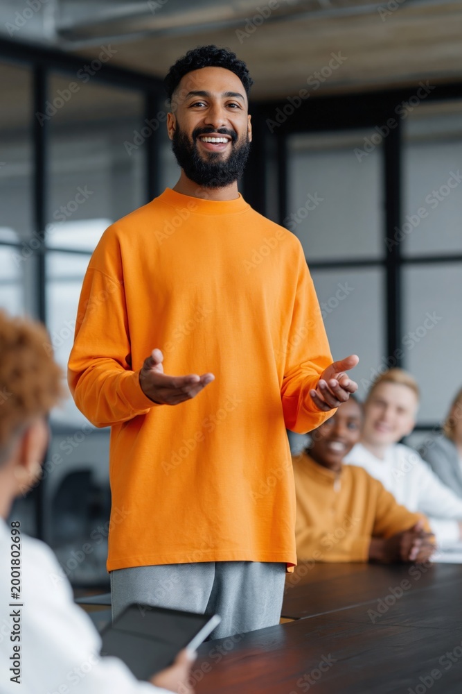 © Andrii Zastrozhnov - Young man presenting to team in modern conference room