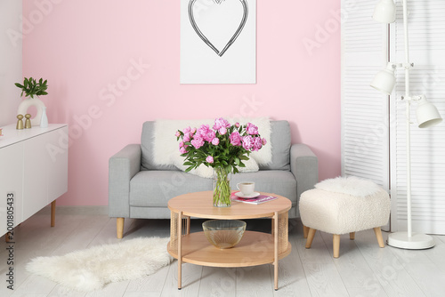 Vase of pink peonies on cof...