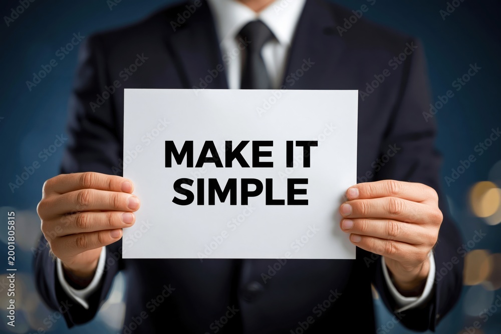 Obraz premium Businessman Holding a Sign Urging to 'Make It Simple'