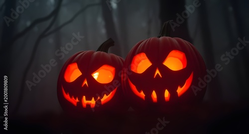 A pair of glowing jack-o'-lanterns with scary expressions in a misty forest, creating a dramatic and eerie Halloween composition.
