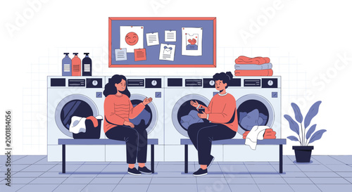 Two women sit on a bench and talk while waiting for their clothes to finish washing in a modern self-service laundromat.