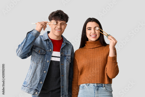 Young couple with sushi on ...