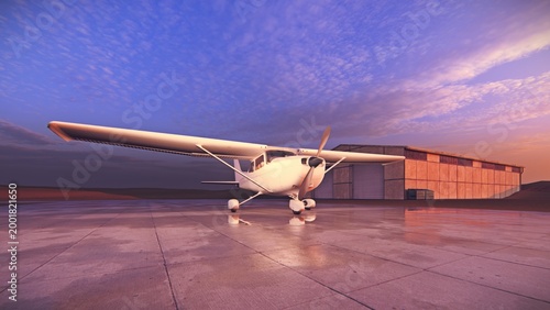 A light aircraft, Cessna, waits on the runway at a small airport
