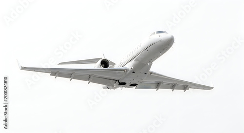 Modern private jet aircraft flying against a bright white sky