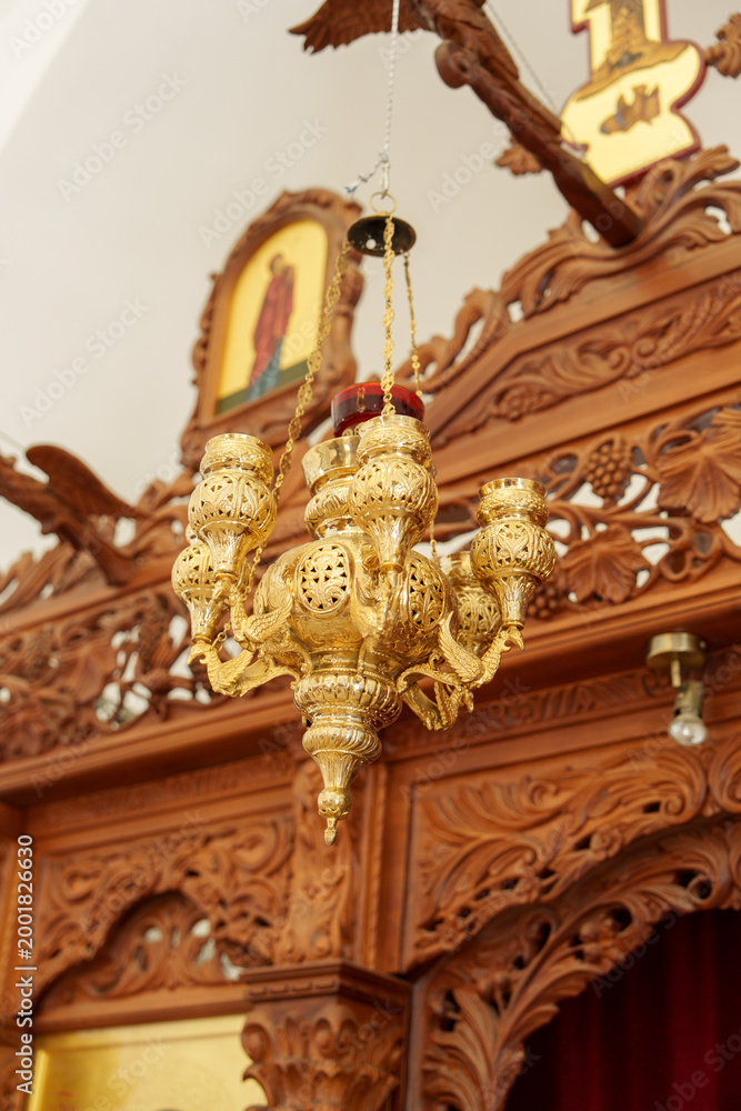 Obraz premium Chandelier hanging in a traditional wooden structure with religious icons