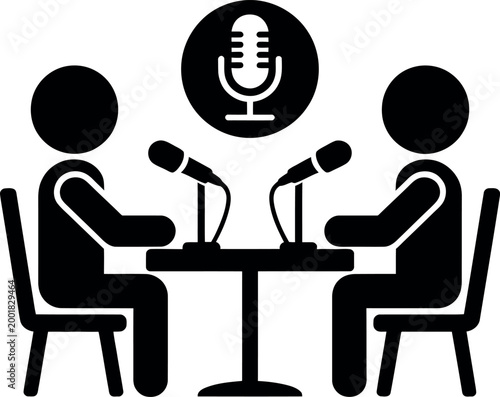 Two people having a conversation with microphones on a table during a podcast recording