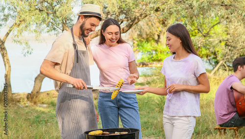 Young friends cooking food ...