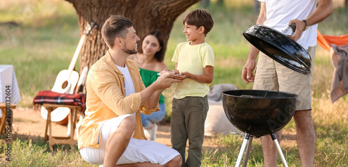 Happy family at barbecue pa...