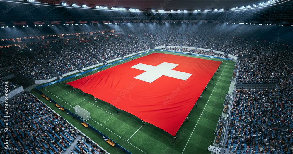 Obraz premium Professional Stadium Soccer Game Championship With Flag of Switzerland Spread Across the Pitch Before Football Match Start. Cheering Crowds of Fans Surround the Field. Aerial Wide Shot