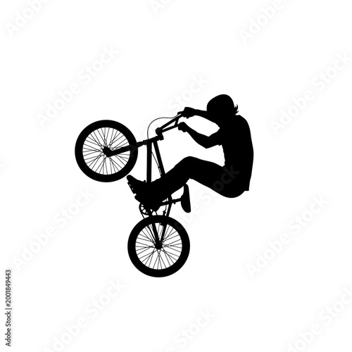 Silhouette of a BMX rider performing a wheelie trick on a bicycle.