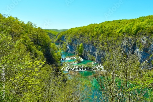 Bild auf Leinwand View of a canyon with tufa cascades, lakes and trees with spring foliage in Plit