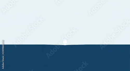 A single white feather floats gently on a dark blue surface.