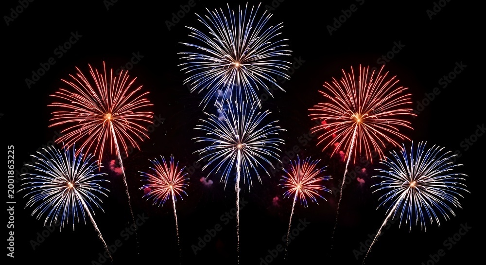 Fototapeta premium Vibrant red, White, And blue fireworks exploding in the night sky on 4th of July, Celebrating American Independence Day with a stunning display of colorful pyrotechnics