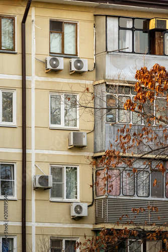 air conditioner, condenser unit, compressor on facade of building. unit of central AC conditioner of HVAC heating ventilation system. Indoor and office air cooling during seasonal temperature rise.