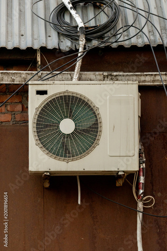 air conditioner, condenser unit, compressor on facade of building. unit of central AC conditioner of HVAC heating ventilation system. Indoor and office air cooling during seasonal temperature rise.