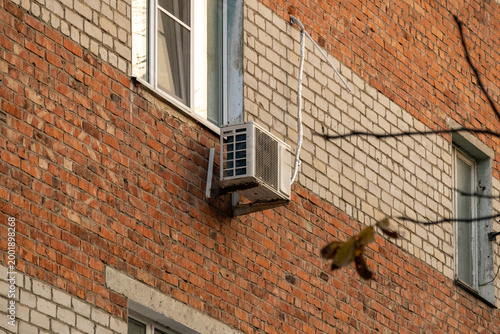 air conditioner, condenser unit, compressor on facade of building. unit of central AC conditioner of HVAC heating ventilation system. Indoor and office air cooling during seasonal temperature rise.
