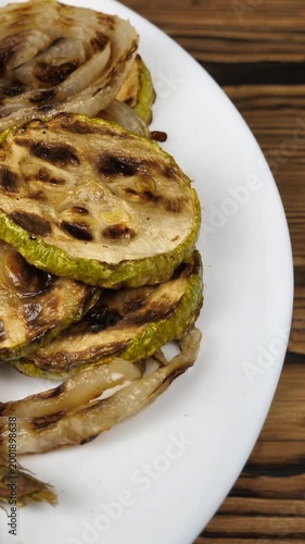 grilled vegetables in a white plate on a wooden background. Delicious healthy vegetarian snack. Healthly food