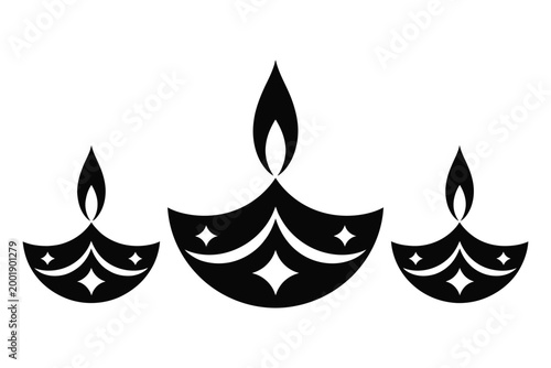 Three decorative black diya lamps