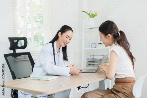  The dentist is talking to the patient and showing them a model of the teeth. (Concept of dental care)
