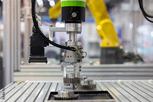 Industrial robotic arm with machine vision camera picking metal gears in automated factory line, Robotic gripper handling steel machine, Automated robotic system smart factory.